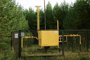 Gas distribution point, fenced with a grid in the forest. The concept of the energy crisis, lack of fuel. Translation flammable, gas photo