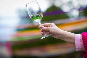 People clinking glasses with wine on the summer terrace of cafe or restaurant photo