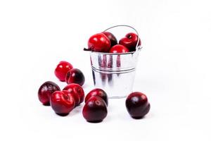 aluminum ice bucket laid in wait for use. stainless multi-colored bucket with red apples photo
