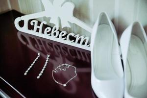 Two white wooden hangers groom and bride photo