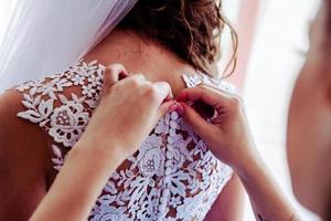 Bridal morning, bride wears dress. photo