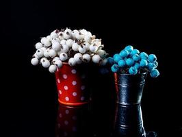 aluminum ice bucket laid in wait for use. stainless multi-colored bucket with white green blue berries in ice photo