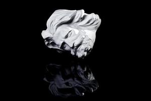 Gypsum copy of famous ancient statue Poseidon head isolated on a white background. photo