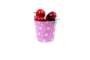 aluminum ice bucket laid in wait for use. stainless multi-colored bucket with red apples photo