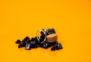 keyboard button in glass in jar in bucket on orange background photo