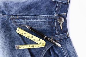 Measuring tape on front blue jeans photo