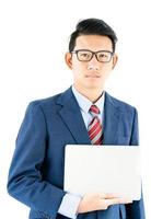 Businessman portrait in suit holding a laptop over white background photo