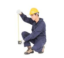 Young worker in unifrom with tape measure isolated on white photo