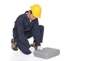 Young handyman sitting with his tool box photo