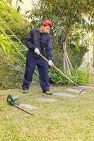 Gardener with garden tools at work photo