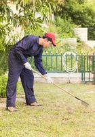 Gardener with garden tools at work photo