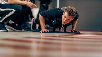 Man Doing Push-Up Exercise During EMS Workout In The Gym photo