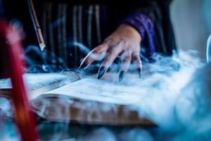 Witch's Hand On Magic Book photo