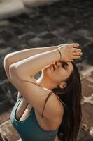 Woman Doing Yoga Outdoors On A Rooftop Terrace photo