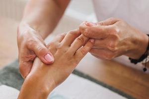 Woman Enjoying Hand Massage At Beauty Salon photo