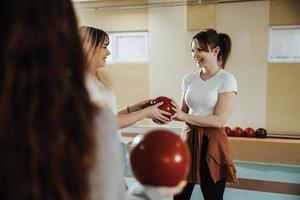 Female Friends Having Fun In A Bowling Alley photo