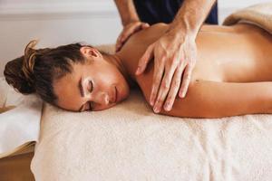 Woman Enjoying Massage In Spa Centre photo