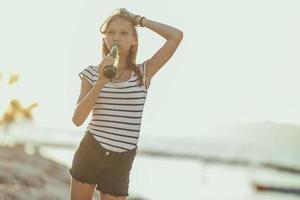 Teenager Girl Having Fun While Enjoying A Summer Vacation At The Beach photo