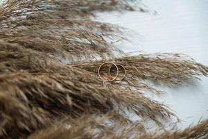 Two wedding rings on the floor with contrast photo