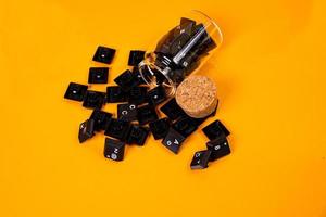 keyboard button in glass in jar in bucket on orange background photo