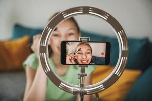 Teenager Girl Making A Video Blog On A Smartphone At Her Home photo