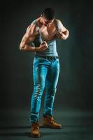 Muscular Male Ripping Shirt photo