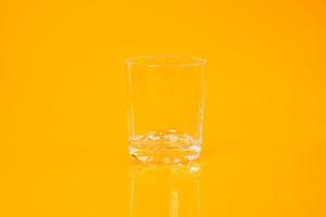 empty glass empty jar empty ice bucket on orange background photo