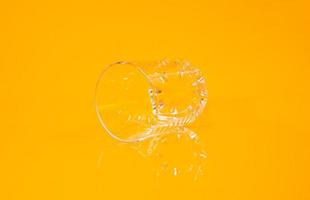 empty glass empty jar empty ice bucket on orange background photo