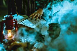 Witch's Hand On Magic Book photo