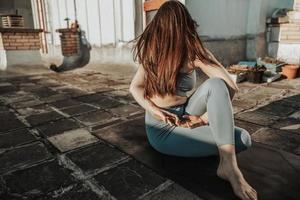 Woman Doing Yoga Outdoors On A Rooftop Terrace At Sunset photo