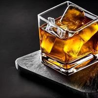 whiskey on clear glass and bottle also diced ice alcohol drawing. picture and image beverage illustration for background photo