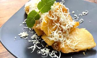 fried cassava with topping grated cheese on top photo