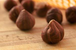 Hazelnuts on a wooden texture background. Hazelnut close-up photo. photo