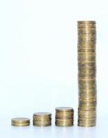 Gold coins on white background. Get rich quick concept. Accumulation of money. Investments. photo