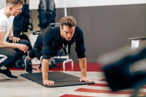 Man Doing Plank Exercise During EMS Workout In The Gym photo