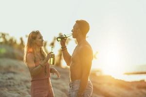 Couple Enjoying Sunset At The Beach photo