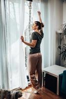 Woman Enjoying View Through The Window In The Morning Sunshine photo