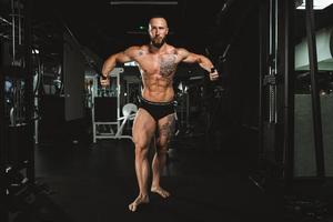 Man Doing Training On Machine For His Chest Muscle At The Gym photo