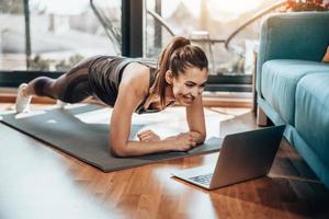 Woman Doing Online Workout At Home photo