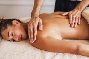 Woman Enjoying Massage In Spa Centre photo