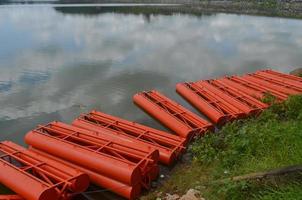 Stock photo of the orange iron tank drum barrier area on the edge of the reservoir