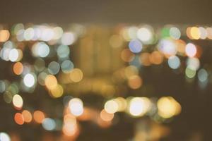 Abstract bokeh cityscape of Bangkok night background with retro filter effect photo