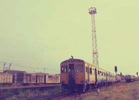 Old train on railway with retro filter effect photo