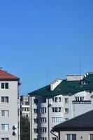 Roofs of modern houses under a cloudless sky. Metal roofing method photo