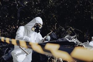 Asian scientist wear Chemical protection suit check danger chemical,working at dangerous zone photo