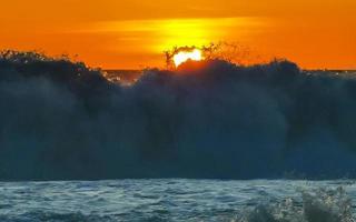 Colorful golden sunset big wave and beach Puerto Escondido Mexico. photo