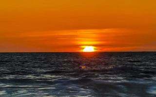 Colorful golden sunset big wave and beach Puerto Escondido Mexico. photo