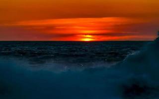 Colorful golden sunset big wave and beach Puerto Escondido Mexico. photo