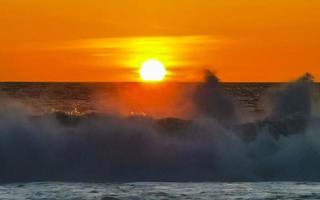 Colorful golden sunset big wave and beach Puerto Escondido Mexico. photo