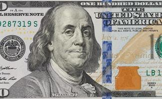 The denomination hundred dollars on isolated white background photo